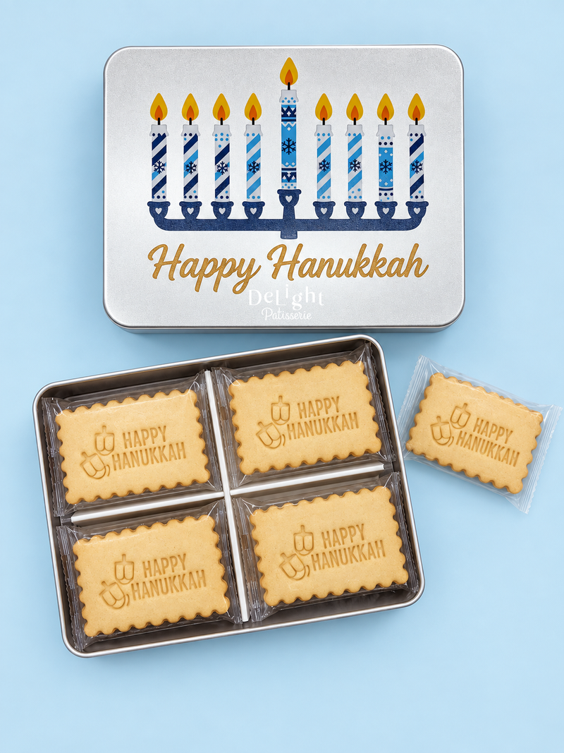 Happy Hanukkah cookie tin featuring a blue-and-white menorah design, filled with shortbread cookies stamped “Happy Hanukkah” and dreidels—a thoughtful Hanukkah gift.