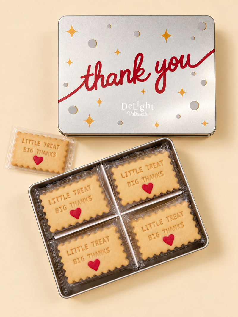 Thank You cookie tin filled with individually wrapped shortbread stamped “LITTLE TREAT BIG THANKS” and decorated with red sugar hearts —a thoughtful appreciation gift. 