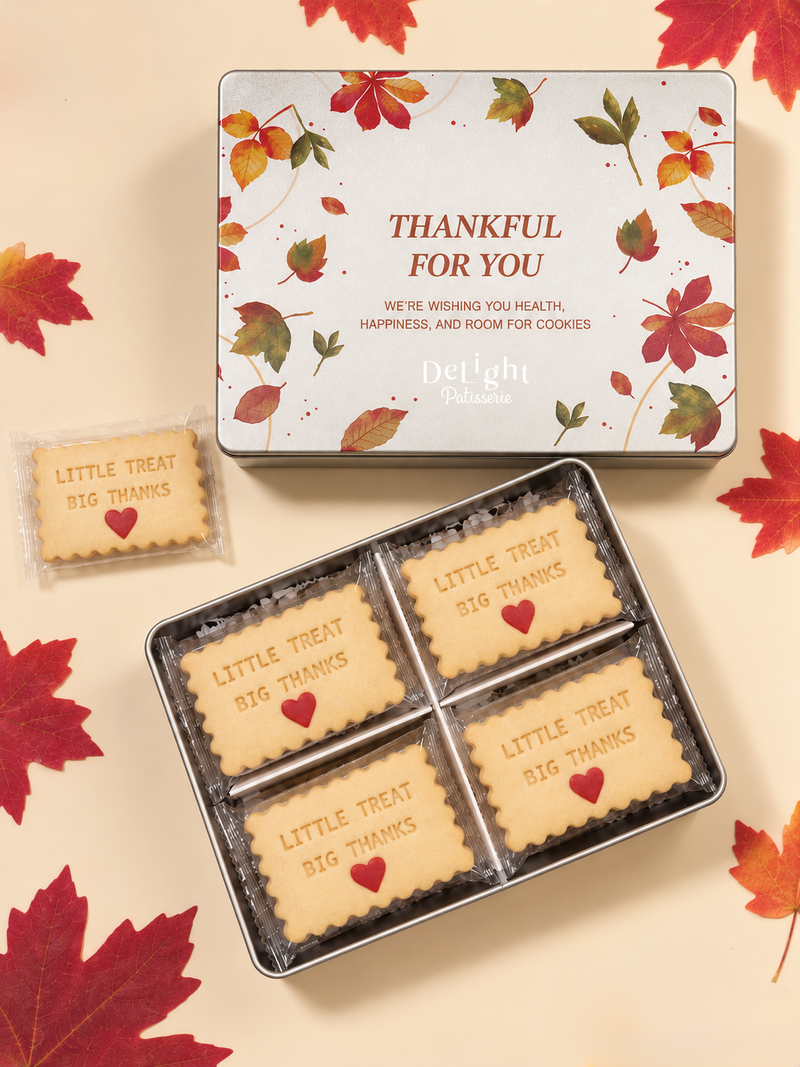 Thanksgiving cookie tin featuring autumn leaves and “Thankful for You,” filled with shortbread stamped “LITTLE TREAT, BIG THANKS” and red hearts- a thoughtful Thanksgiving gift