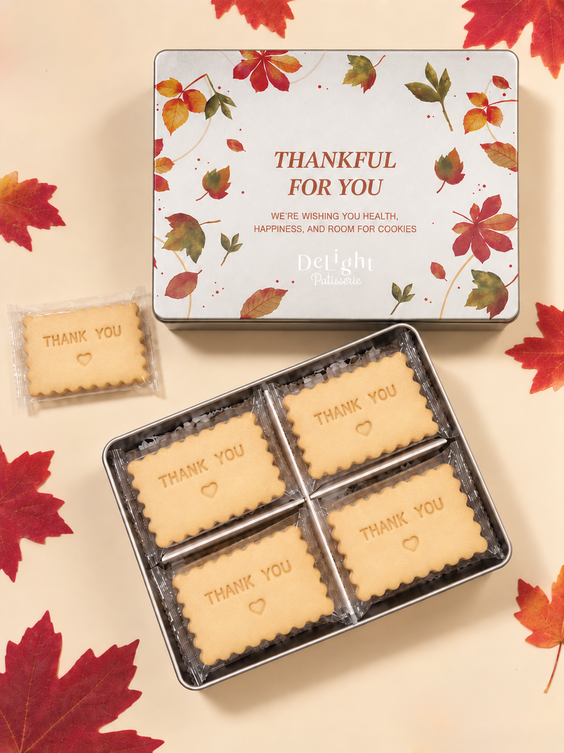Thanksgiving cookie tin featuring autumn leaves and “Thankful for You,” filled with shortbread stamped “THANK YOU” and stamped hearts- a thoughtful Thanksgiving gift