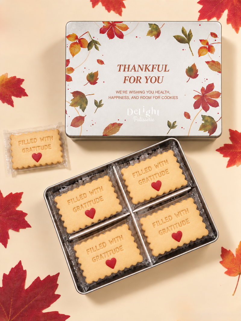 Thanksgiving cookie tin featuring autumn leaves and “Thankful for You,” filled with shortbread stamped “FILLED WITH GRATITUDE” and decorated with red sugar hearts- a thoughtful Thanksgiving gift